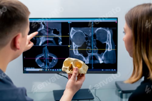 Preview: the radiologist doctor looks at the screen on which the 3D image of the nose scan shows the patient