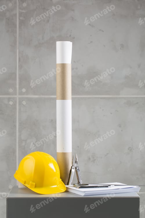 Preview: Yellow Helmet, Papers And Pilers On Concrete Background