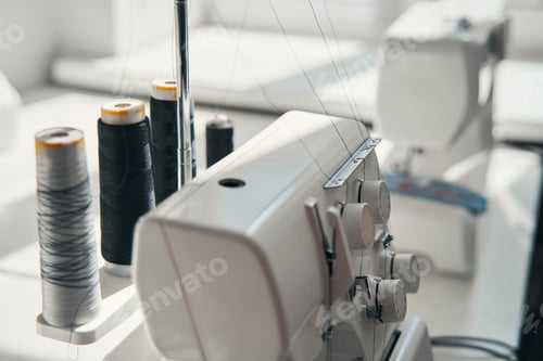 Preview: Sewing machine and thread on tailor desk