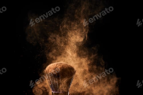 Preview: cosmetic brush with colorful golden powder explosion on black background
