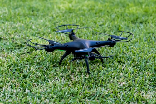 Preview: Camera Drone landing take off on a green grass