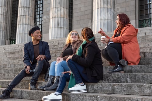 Preview: Portrait of a group of friends sitting on stairs