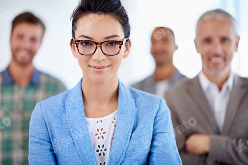 Preview: Poised and professional. Beautiful young woman smiling, with colleagues standing in the background.