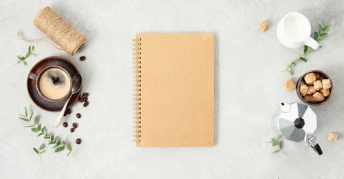 Preview: empty notebook, Moka pot, espresso cup, milk, sugar and coffee beans