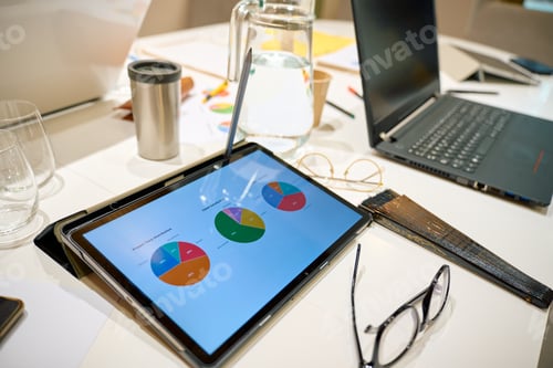 Preview: Business meeting table showing data analysis charts