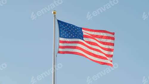 Preview: Close Up Of American Flag Flying Against Clear Blue Sky