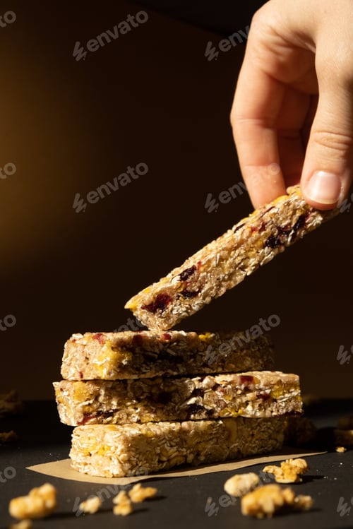 Preview: Woman takes Homemade Granola energy bar. Variety of protein granola breakfast bars, with nuts
