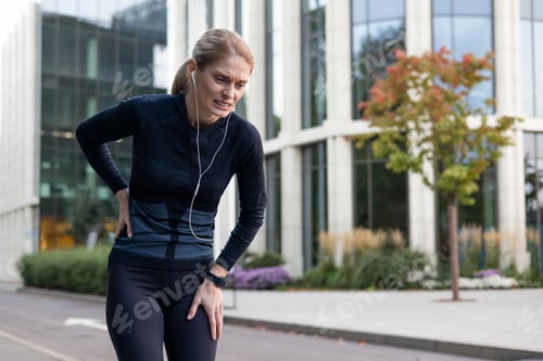 Preview: Female runner experiencing side stitch pain during urban workout