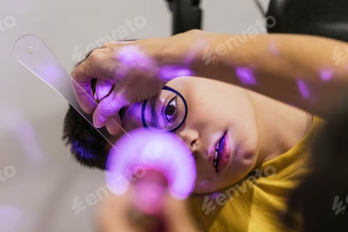 Preview: Child with disability undergoing eye exam with optometrist