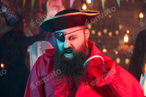 Preview: Portrait of handsome bearded man screaming and dressed up like a pirate at halloween celebration