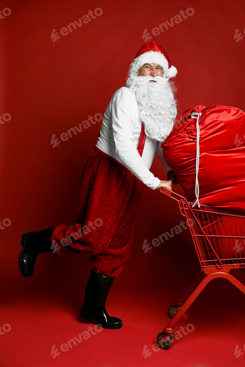 Preview: Caucasian Santa Claus pulling shopping cart full of Christmas's presents