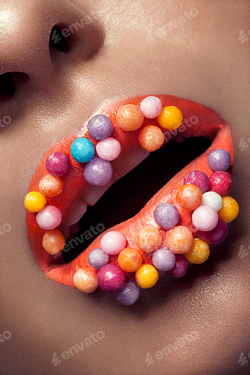 Preview: Close up of creative make up on lips with lolipops
