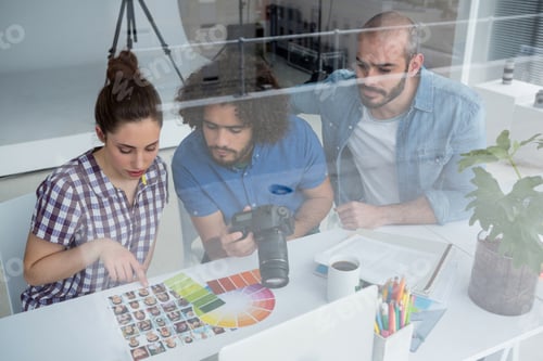 Preview: Team of photographers working together at desk