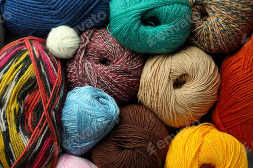 Preview: Different balls of woolen knitting yarns as background, top view