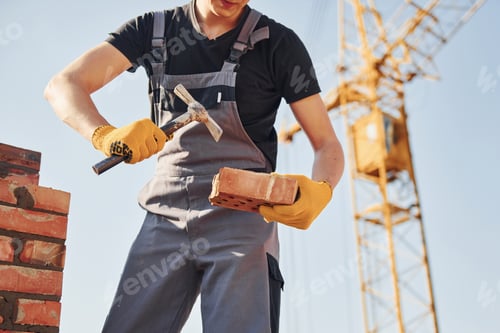 Preview: Construction worker in uniform and safety equipment have job on building