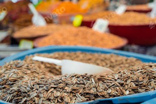 Preview: Roasted sunflower seeds in market with spices displayed