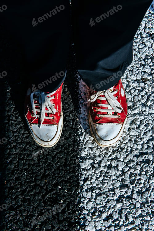 Preview: pair red shoe on the pavement. Black asphalt texture