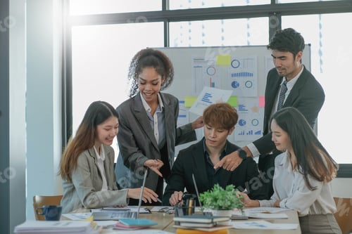 Preview: Asian business woman leader workers a paper business plan in a group meeting. Emphasis on female