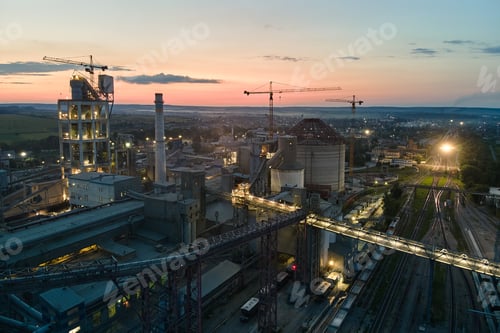 Preview: Aerial view of cement factory with high concrete plant structure and tower cranes