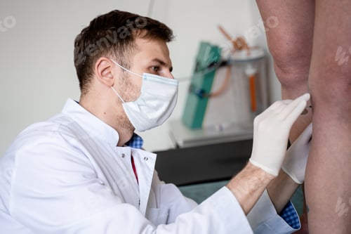 Preview: Doctor in Mask Treating Patient's Leg Veins