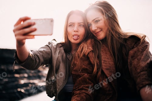Preview: Best Friends taking selfie with smart phone together