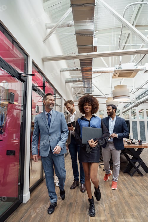 Preview: Group of multiethnic business people crossing office together