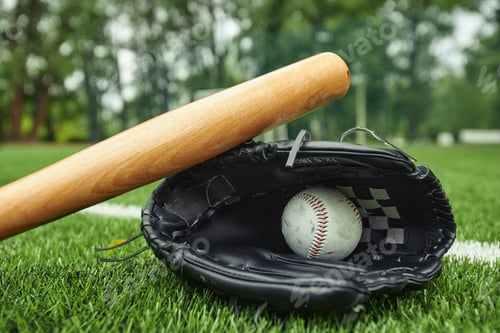 Preview: Baseball equipments on green field outdoors