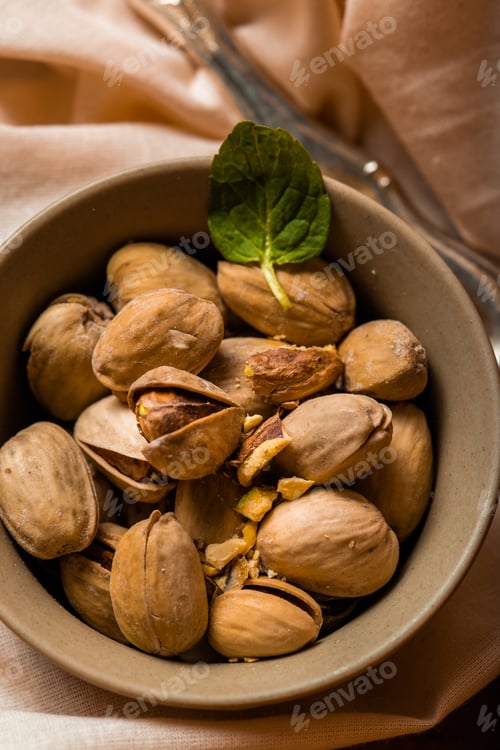 Preview: pistachios in a small beige bowl surrounded by thyme