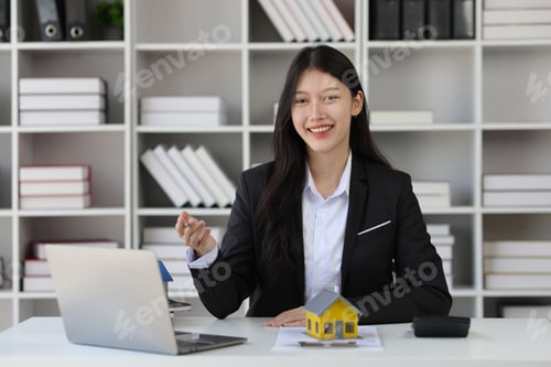 Preview: Portrait of businesswoman, real estate agent working on paperwork in the office.