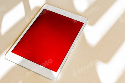 Preview: Tablet with red screen on a desk - copy space, technology concept