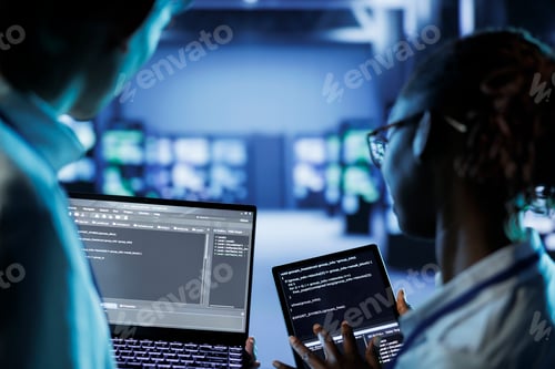 Data center specialists code on tablet