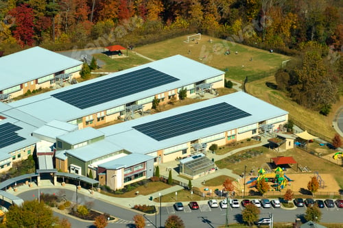 Preview: View from above of american school campus with roof covered with photovoltaic solar panels