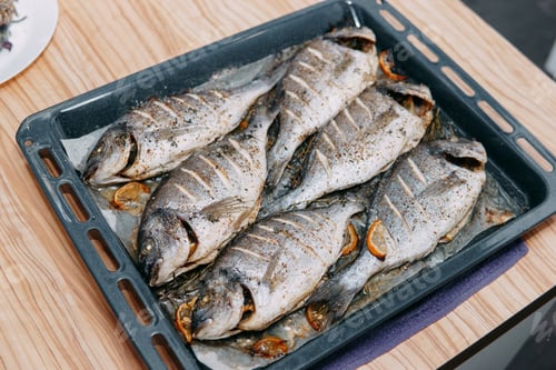 Preview: Baked Dorado fish in the oven. Cooking Dorado fish in the cooking class. Baked fish, selective focus