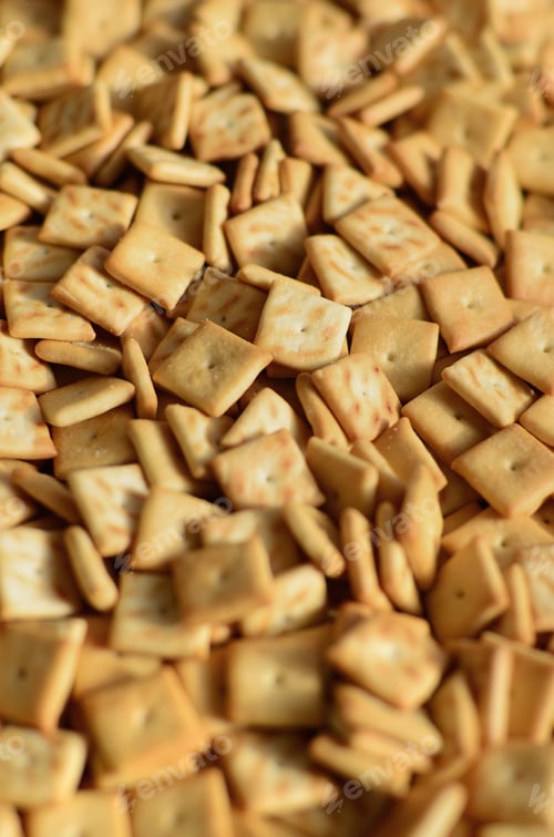 Preview: Background texture of small edible squares baked from dough and sprinkled with salt. A l
