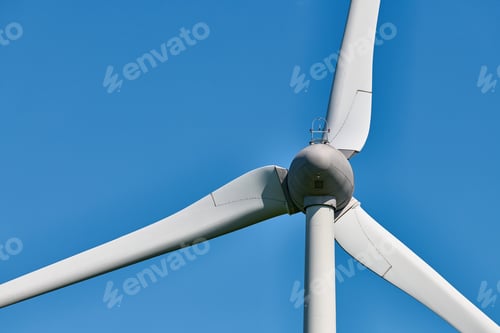 Preview: Close up of wind turbine against blue sky