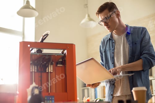 Preview: Young Man Operating 3D Printer
