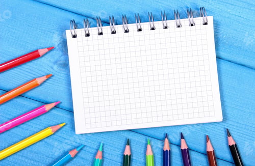 Preview: Colorful crayons and notepad on boards, school accessories, copy space for text