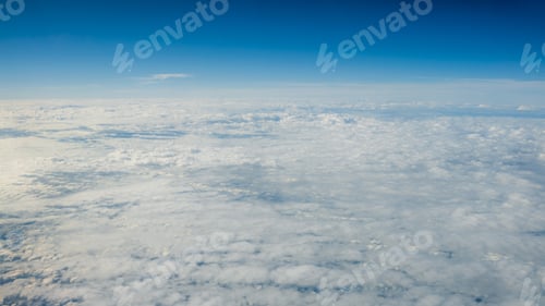 Preview: The beautiful cloudscape with clear blue sky. A view from airplane window.