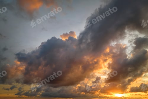 Preview: Colofrul clouds brightly illuninated by setting sun on evening sky.