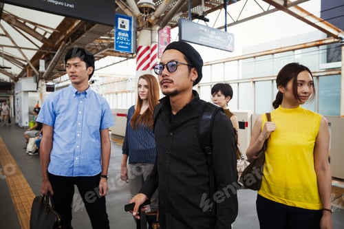 Preview: Small group of people standing on the platform of a subway station, Tokyo commuters.