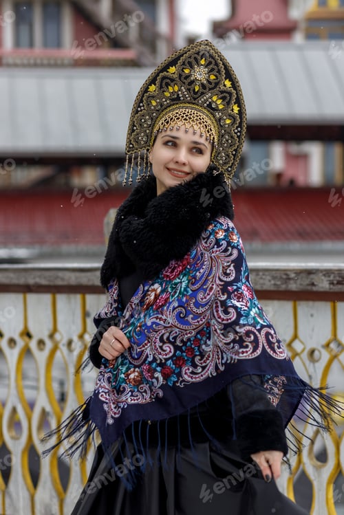 Preview: Beautiful portrait of a young Slavic woman in a black dress and kokoshnik on the street.