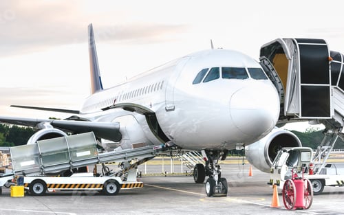 Preview: Side view of airplane at airport terminal gate