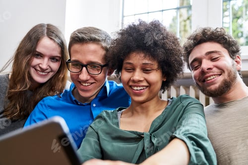 Preview: Smiling young people looking at tablet