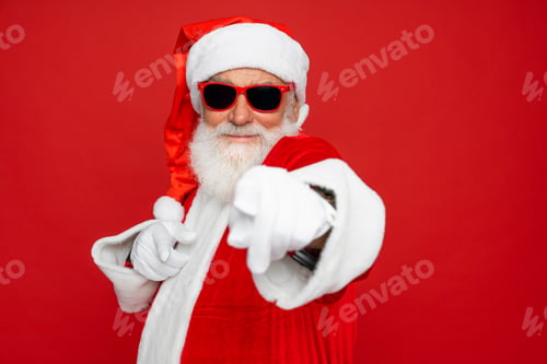 Preview: Excited Santa Claus finger gesture choosing you for advertising isolated on red background close up