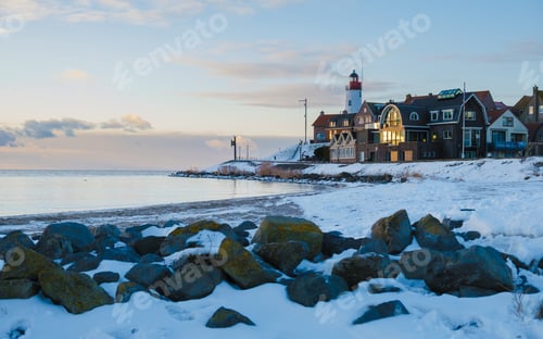Preview: Lighthouse of Urk during winter with snow in the Netherlands on a sunny day