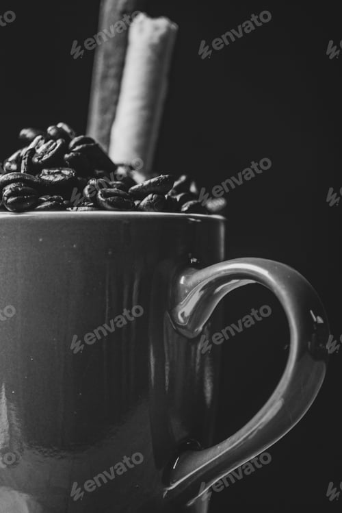 Preview: Grayscale shot of coffee beans in a mug