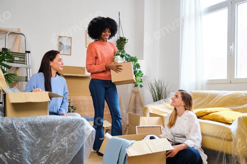 Preview: Group of three female friends moving into student flat.