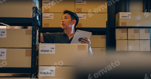 Preview: Asian man use barcode scanner scan box in shelf and put data in digital tablet cut stock online.