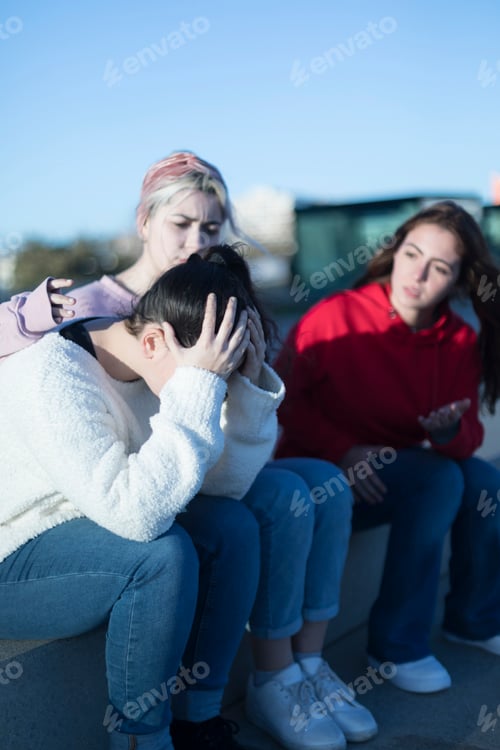 Preview: Woman comforting friend, third person engaged