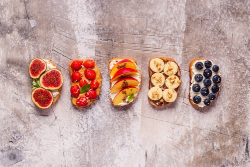 Preview: Variety of Healthy Fruit Topped Toasts on a Textured Background